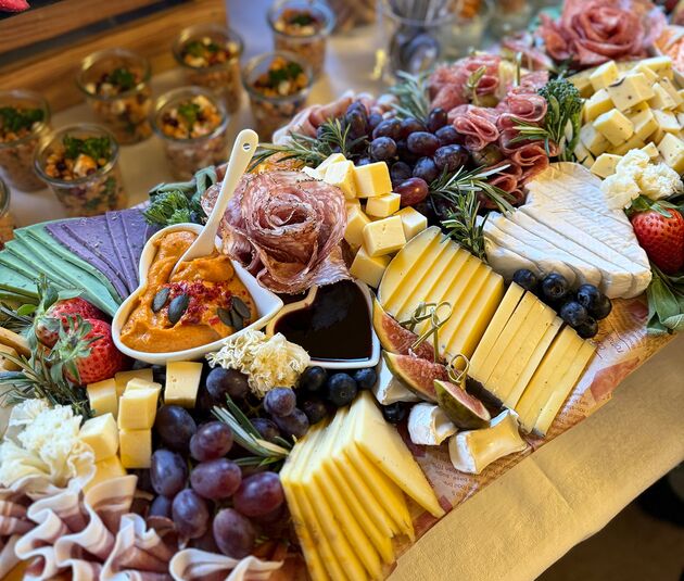 Detailaufnahme einer Käse- und Wurstplatte mit Früchten